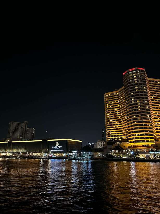 Bangkok: Chao Phraya River Cruise with Indian Buffet Dinner - Wat Arun, the Grand Palace, and the illuminated skyline from the river