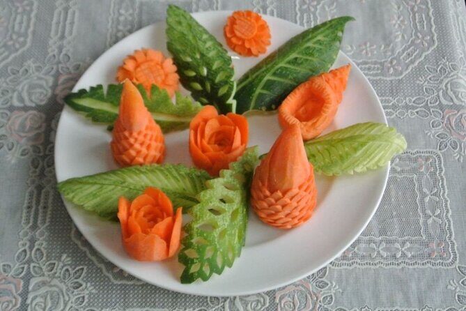 Half Day Professional Thai Fruit and Vegetable Carving Class - The carving process: tomato flowers, cucumber leaves, and plate-ready details